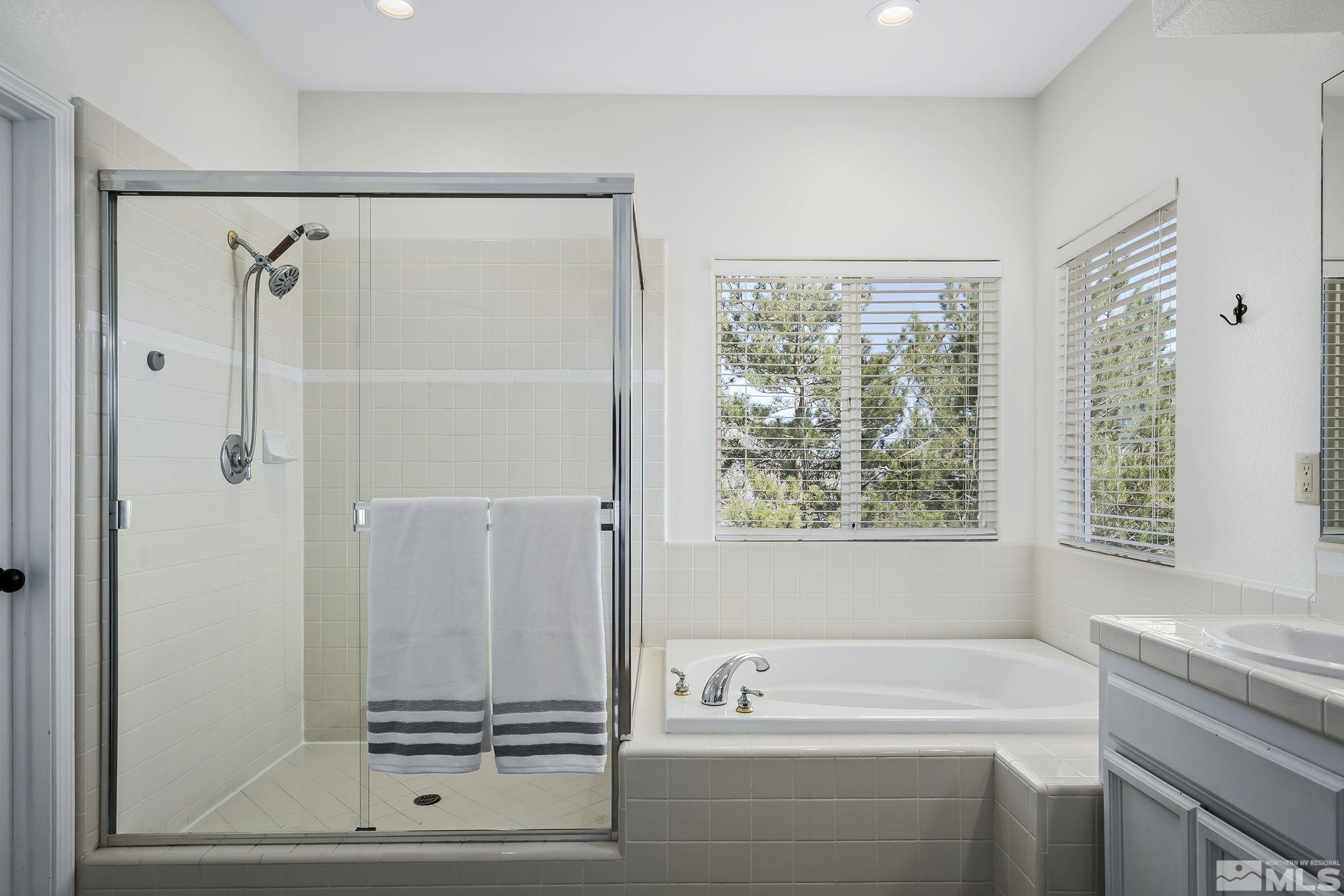 5016 East Albuquerque Road Reno, NV 89511 - Photo 23 of 38 a bathroom with a shower sink and a bathtub