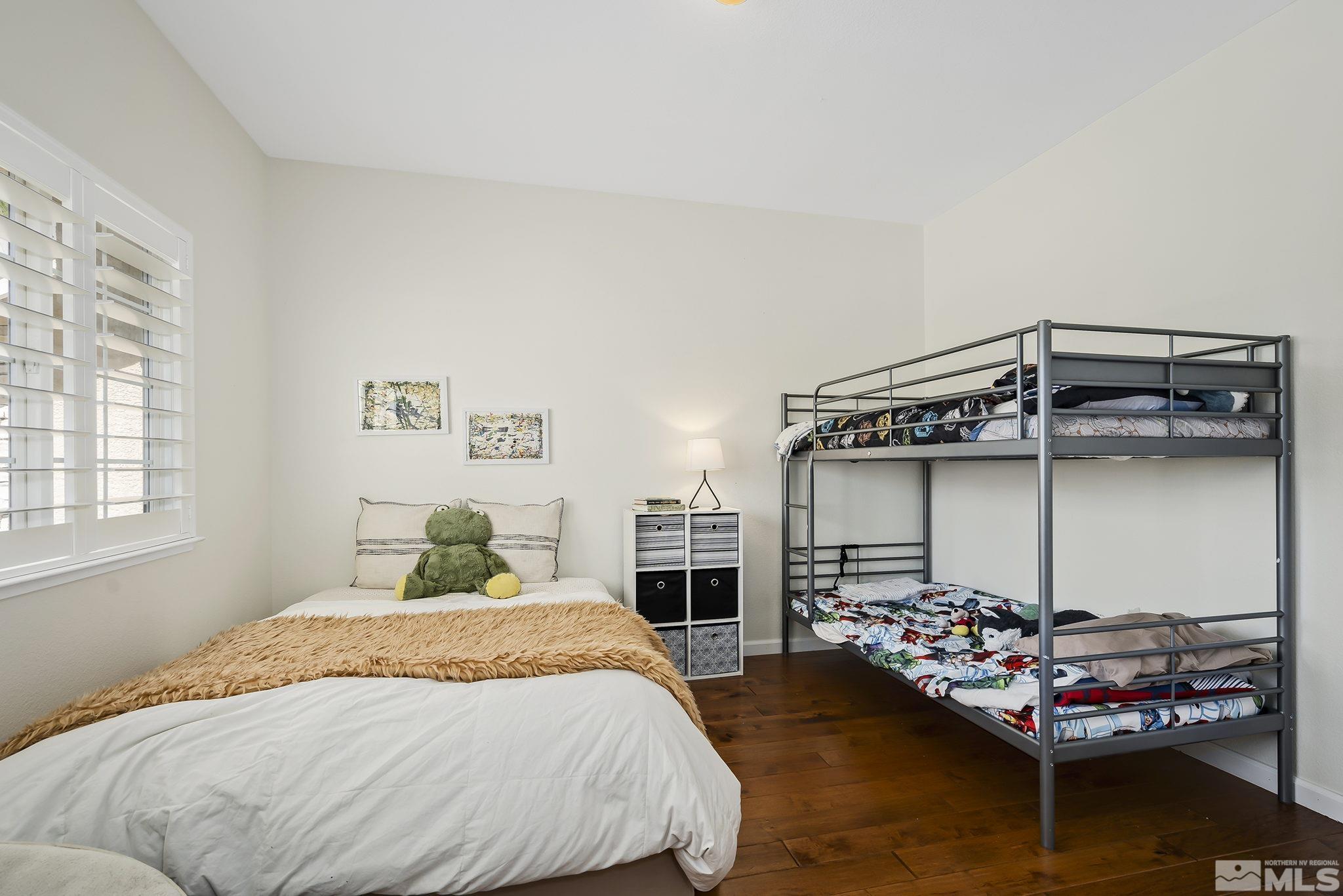 5016 East Albuquerque Road Reno, NV 89511 - Photo 28 of 38 a bedroom with a bed a ceiling fan and a window