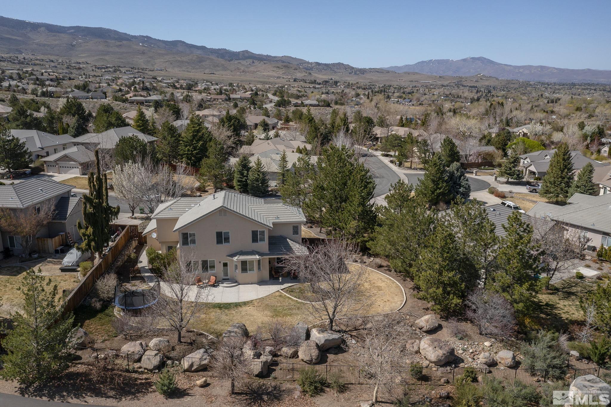 5016 East Albuquerque Road Reno, NV 89511 - Photo 36 of 38 an aerial view of a house with a mountain in the background