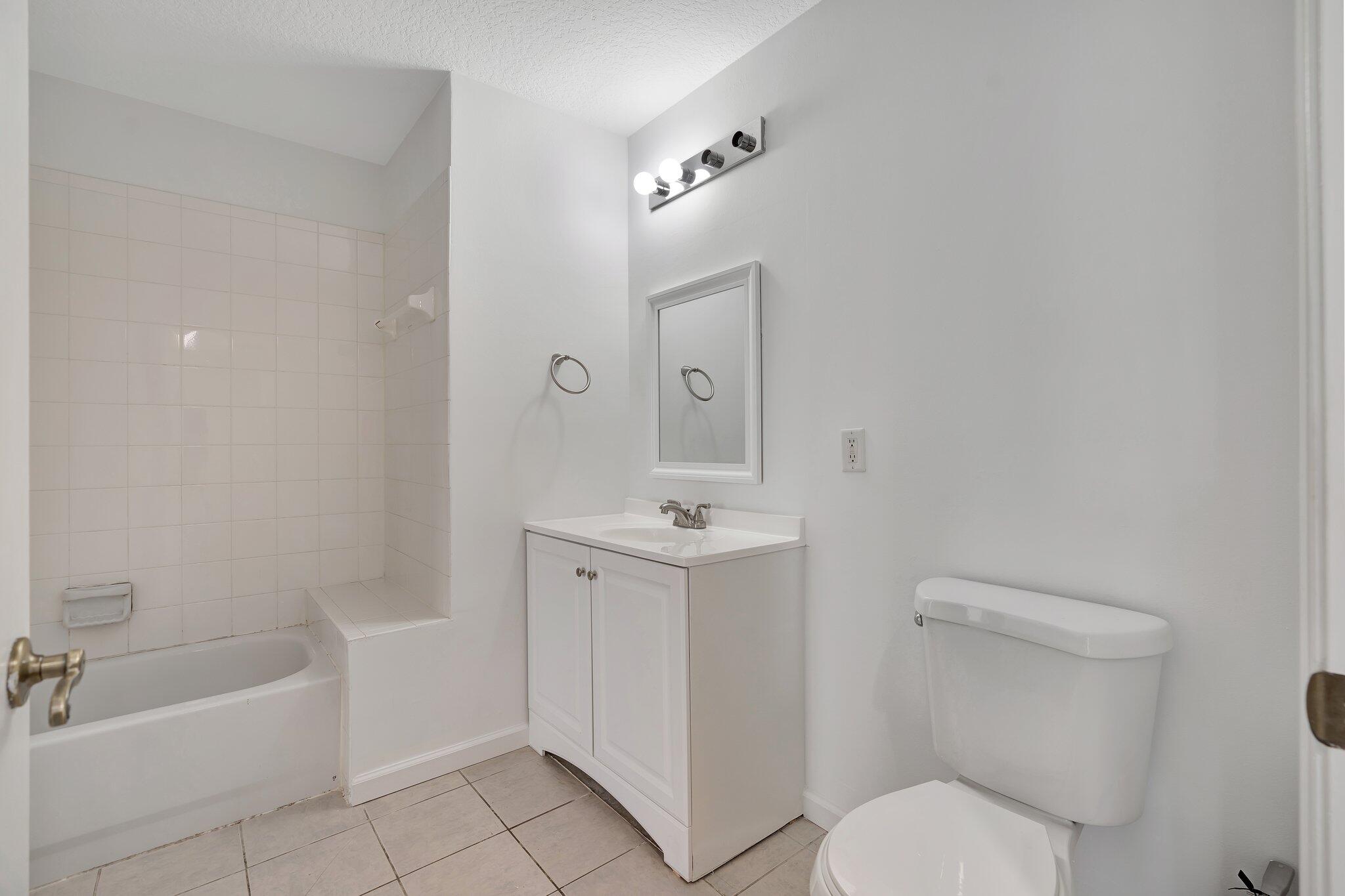1209 Main Street, Unit 302 Jupiter, FL 33458 - Photo 22 of 40 a bathroom with a sink a toilet and shower