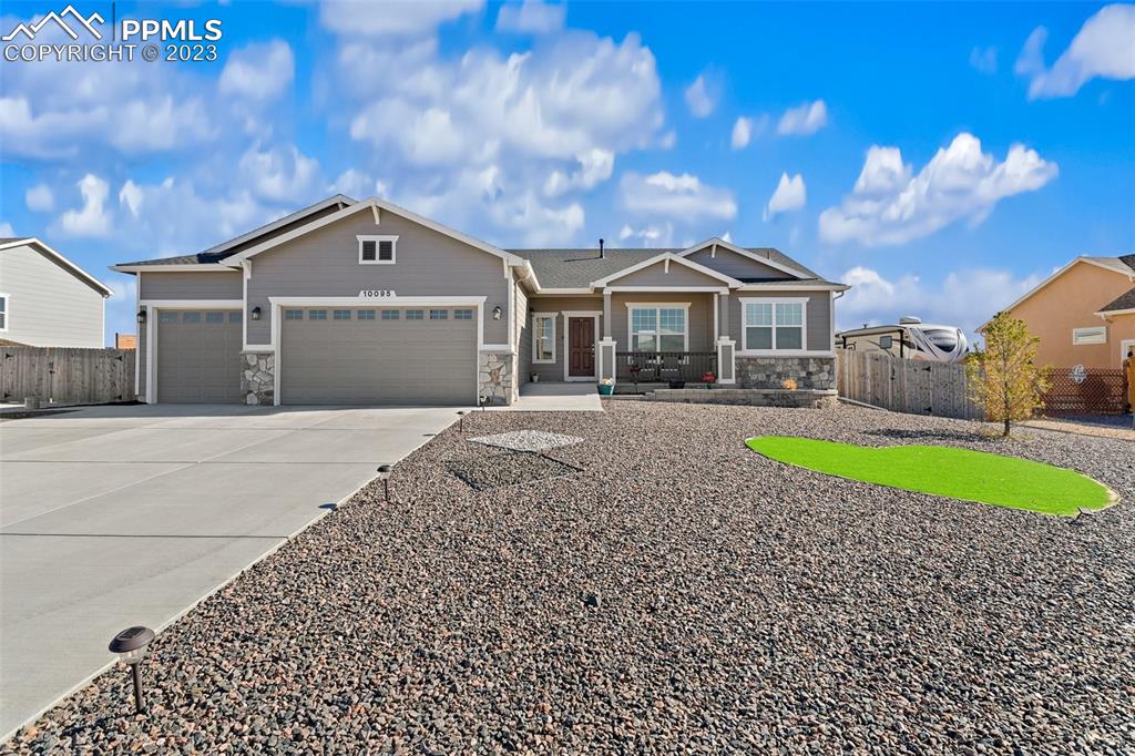 10095 Keating Drive Peyton, CO 80831 - Photo 1 of 31 a front view of a house with garden