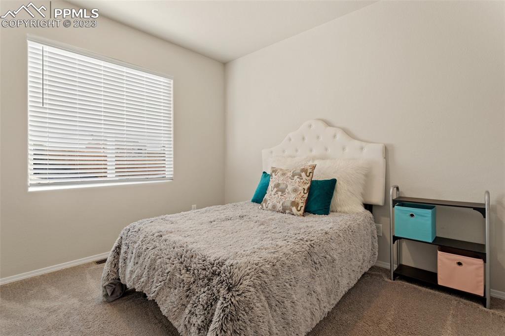 10095 Keating Drive Peyton, CO 80831 - Photo 13 of 31 a bedroom with a bed and a window