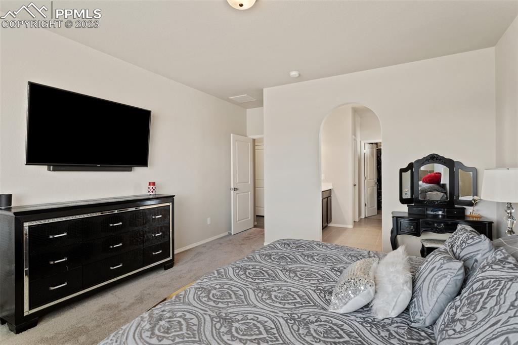 10095 Keating Drive Peyton, CO 80831 - Photo 14 of 31 a bedroom with a bed and a television