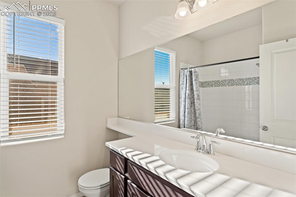 10095 Keating Drive Peyton, CO 80831 - Photo 15 of 31 a bathroom with a sink a toilet and shower