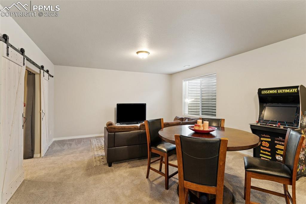 10095 Keating Drive Peyton, CO 80831 - Photo 16 of 31 a work room with furniture and a flat screen tv