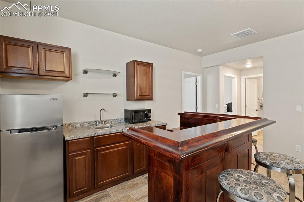 10095 Keating Drive Peyton, CO 80831 - Photo 21 of 31 a room with furniture and mirror