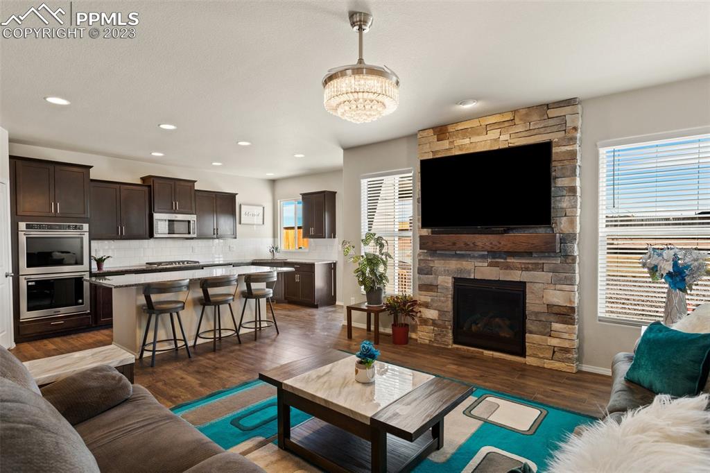 10095 Keating Drive Peyton, CO 80831 - Photo 4 of 31 a living room with furniture a fireplace and a flat screen tv
