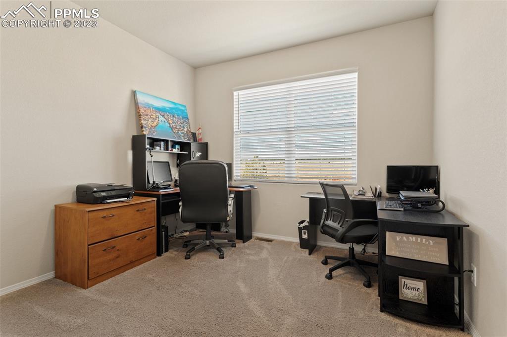 10095 Keating Drive Peyton, CO 80831 - Photo 9 of 31 a view of a workspace with furniture and a window