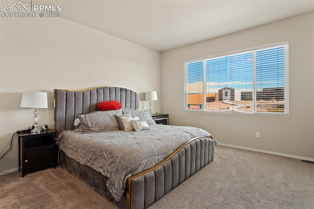 10095 Keating Drive Peyton, CO 80831 - Photo 10 of 31 a bedroom with a bed and a window