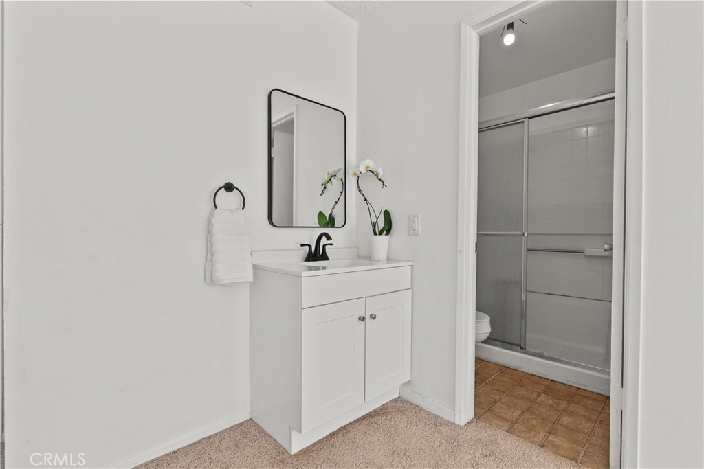 21124 Rosedell Drive Saugus, CA 91350 - Photo 12 of 14 a bathroom with a sink and a mirror