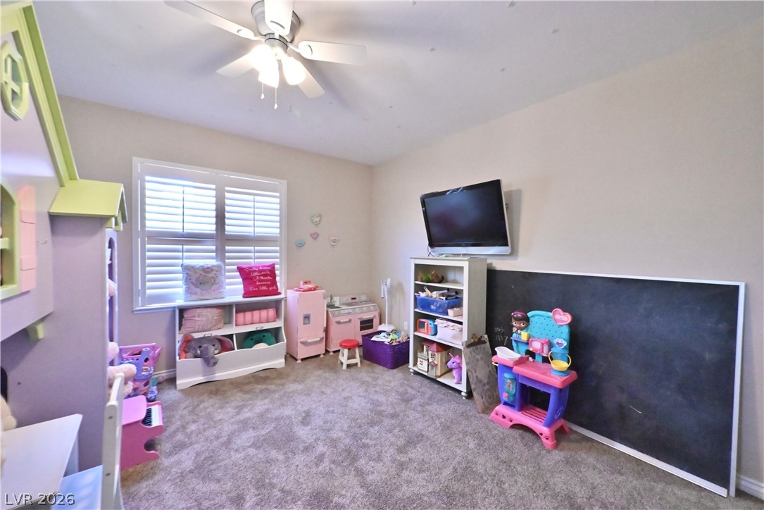 2729 Kildrummie Street Henderson, NV 89044 - Photo 33 of 42 A cheerful children's room offers ample play space with carpeted flooring and abundant natural light.
