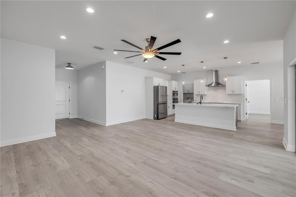 2324 Orange Tree Drive Edgewater, FL 32141 - Photo 11 of 59 a view of a kitchen with a sink and a refrigerator