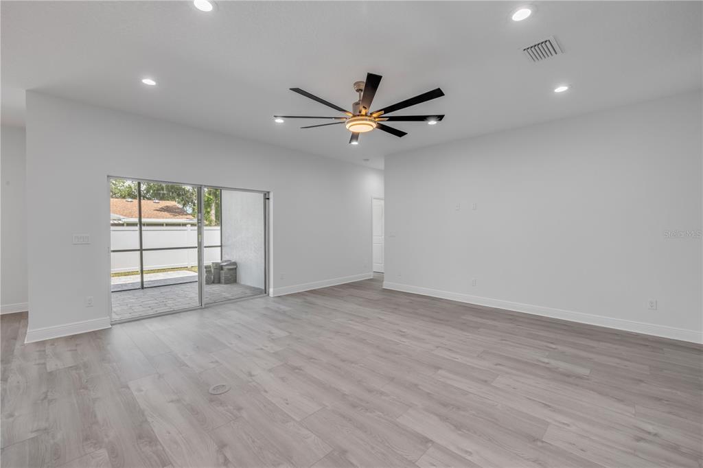 2324 Orange Tree Drive Edgewater, FL 32141 - Photo 13 of 59 wooden floor in an empty room with a window