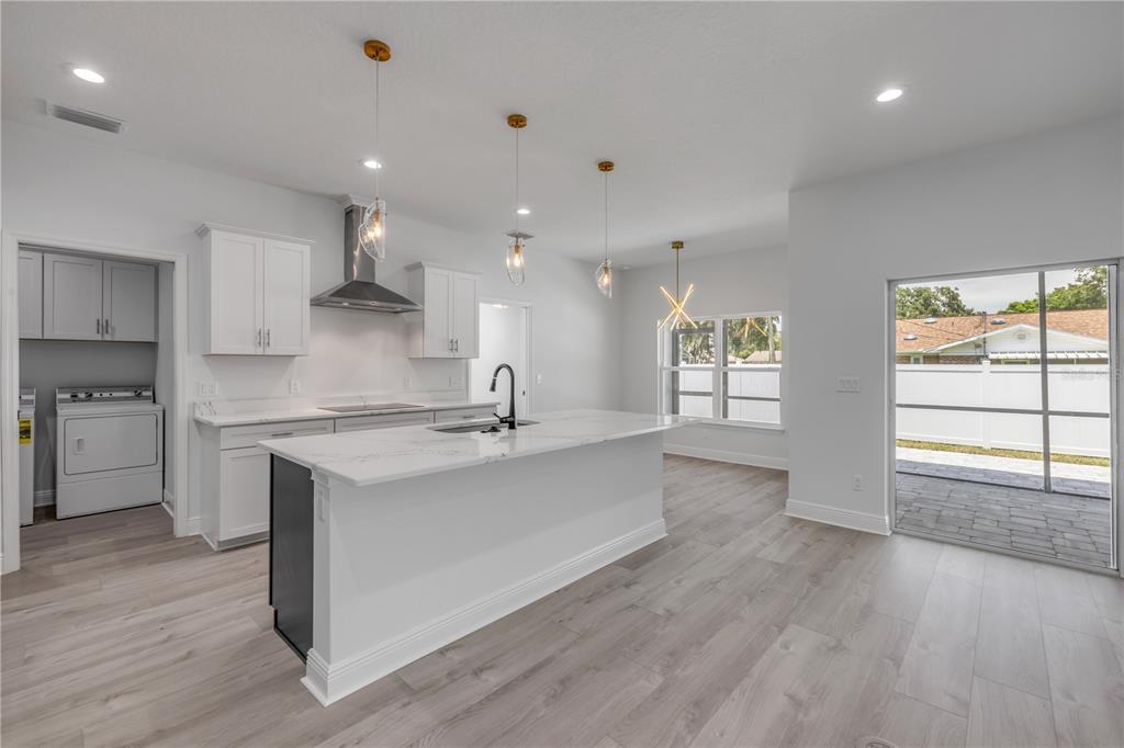 2324 Orange Tree Drive Edgewater, FL 32141 - Photo 14 of 59 a large kitchen with stainless steel appliances a large counter top a sink a stove and a refrigerator