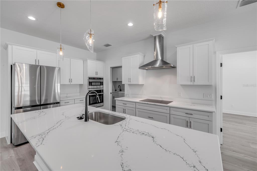 2324 Orange Tree Drive Edgewater, FL 32141 - Photo 17 of 59 a kitchen with stainless steel appliances a sink stove and refrigerator