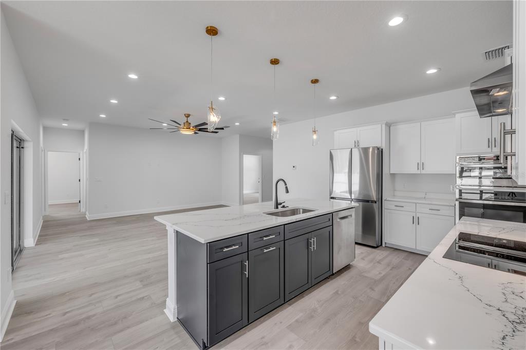 2324 Orange Tree Drive Edgewater, FL 32141 - Photo 21 of 59 a kitchen with a sink a stove a refrigerator and a stove