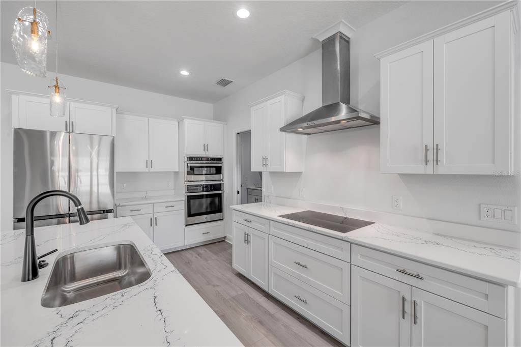 2324 Orange Tree Drive Edgewater, FL 32141 - Photo 23 of 59 a kitchen with stainless steel appliances a sink and a stove