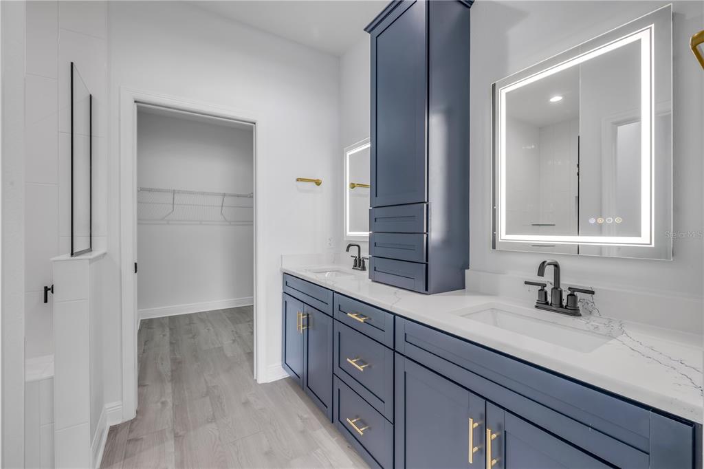 2324 Orange Tree Drive Edgewater, FL 32141 - Photo 31 of 59 a bathroom with a granite countertop sink and a mirror