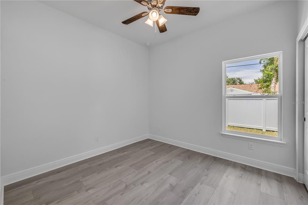 2324 Orange Tree Drive Edgewater, FL 32141 - Photo 35 of 59 wooden floor in an empty room with a window