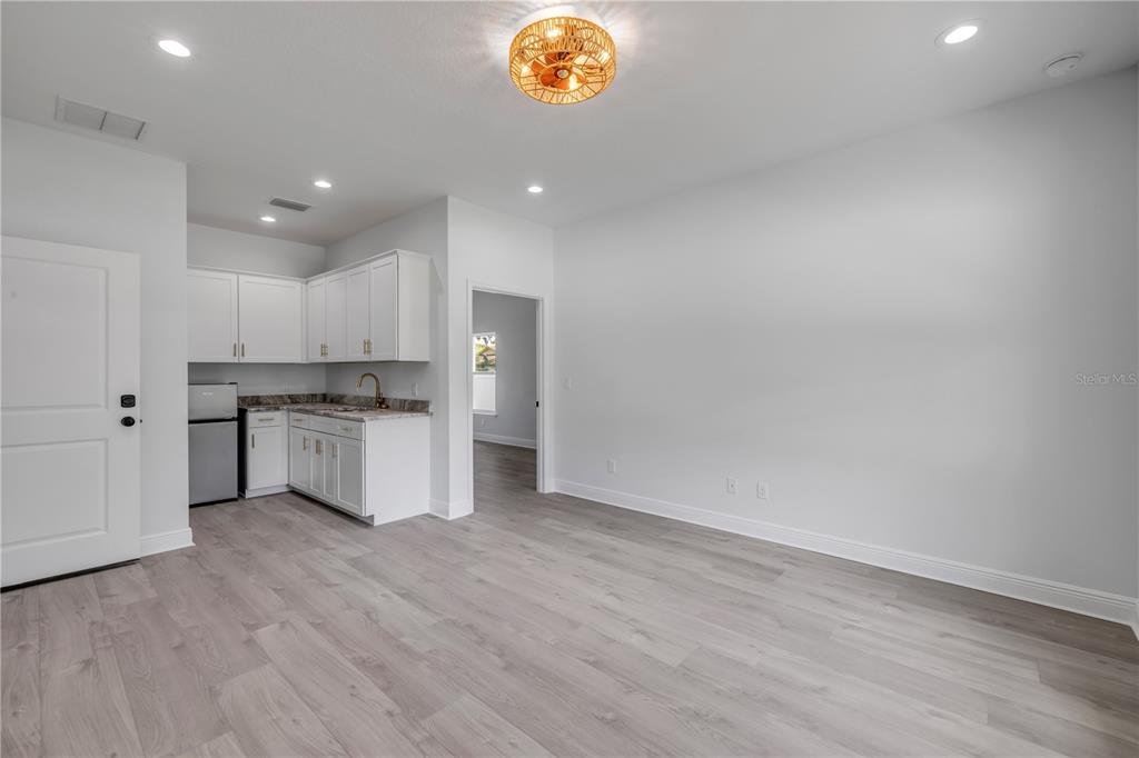 2324 Orange Tree Drive Edgewater, FL 32141 - Photo 42 of 59 a large white kitchen with wooden floor and a sink