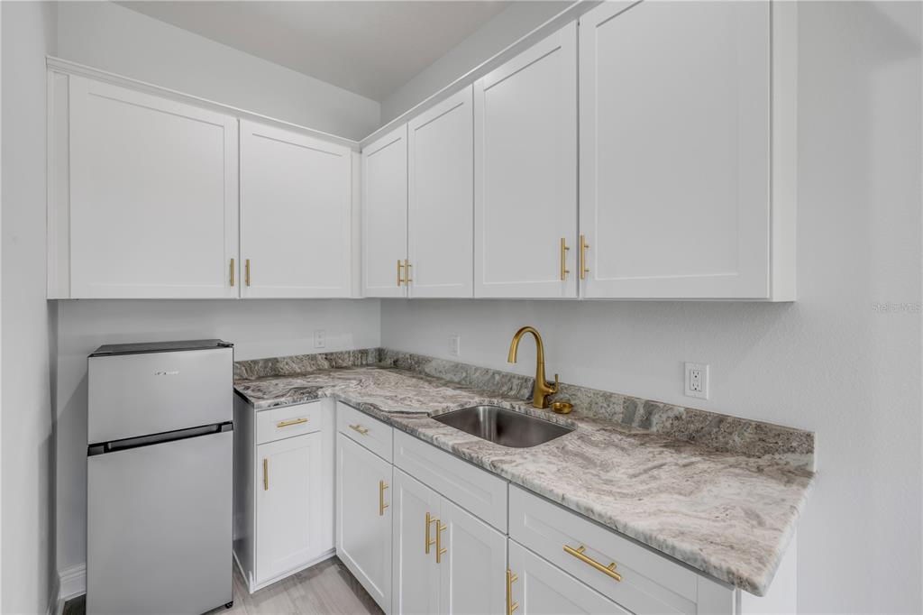 2324 Orange Tree Drive Edgewater, FL 32141 - Photo 45 of 59 a kitchen with appliances a sink and cabinets