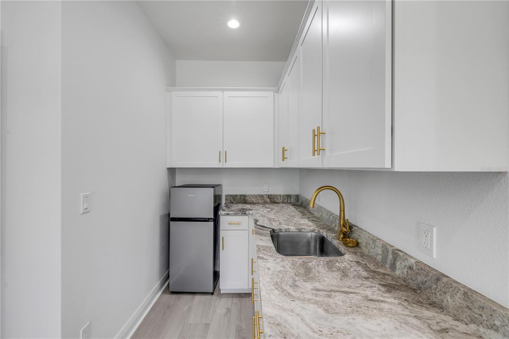 2324 Orange Tree Drive Edgewater, FL 32141 - Photo 46 of 59 a kitchen with a sink and cabinets