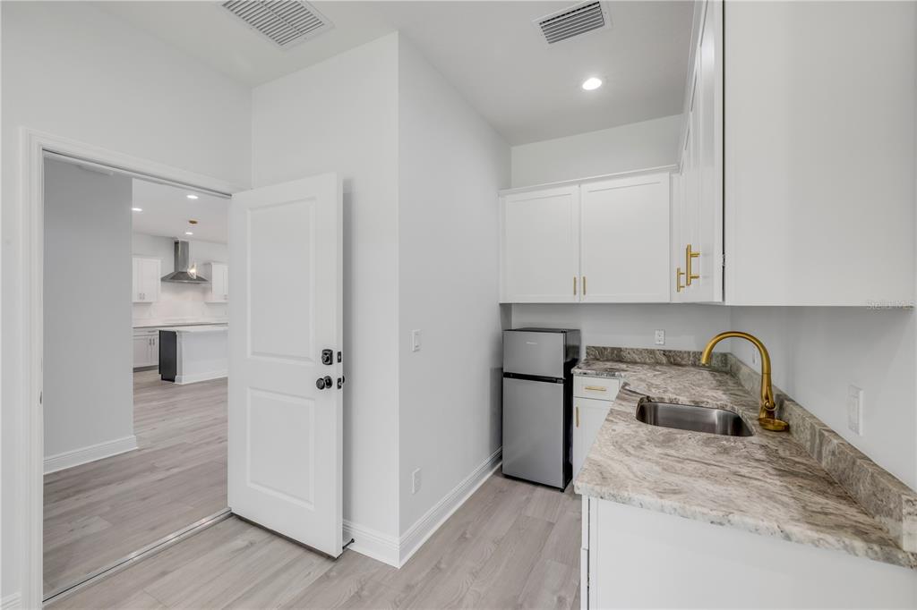 2324 Orange Tree Drive Edgewater, FL 32141 - Photo 47 of 59 a kitchen with refrigerator and cabinets