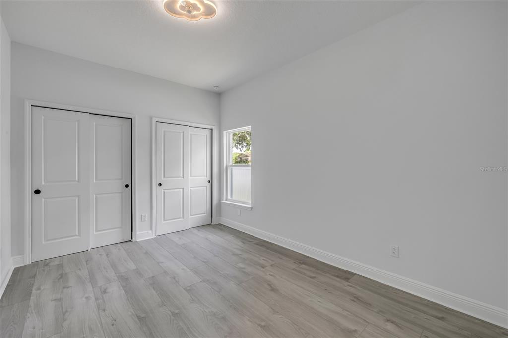 2324 Orange Tree Drive Edgewater, FL 32141 - Photo 48 of 59 a view of an empty room with wooden floor and closet