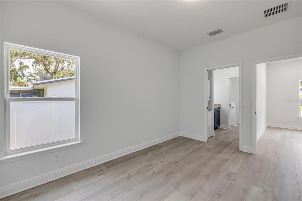 2324 Orange Tree Drive Edgewater, FL 32141 - Photo 49 of 59 a view of an empty room with wooden floor and a window