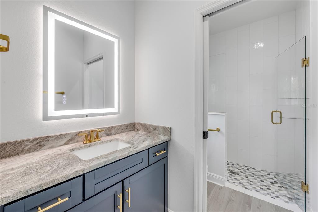 2324 Orange Tree Drive Edgewater, FL 32141 - Photo 52 of 59 a bathroom with a granite countertop sink and a mirror