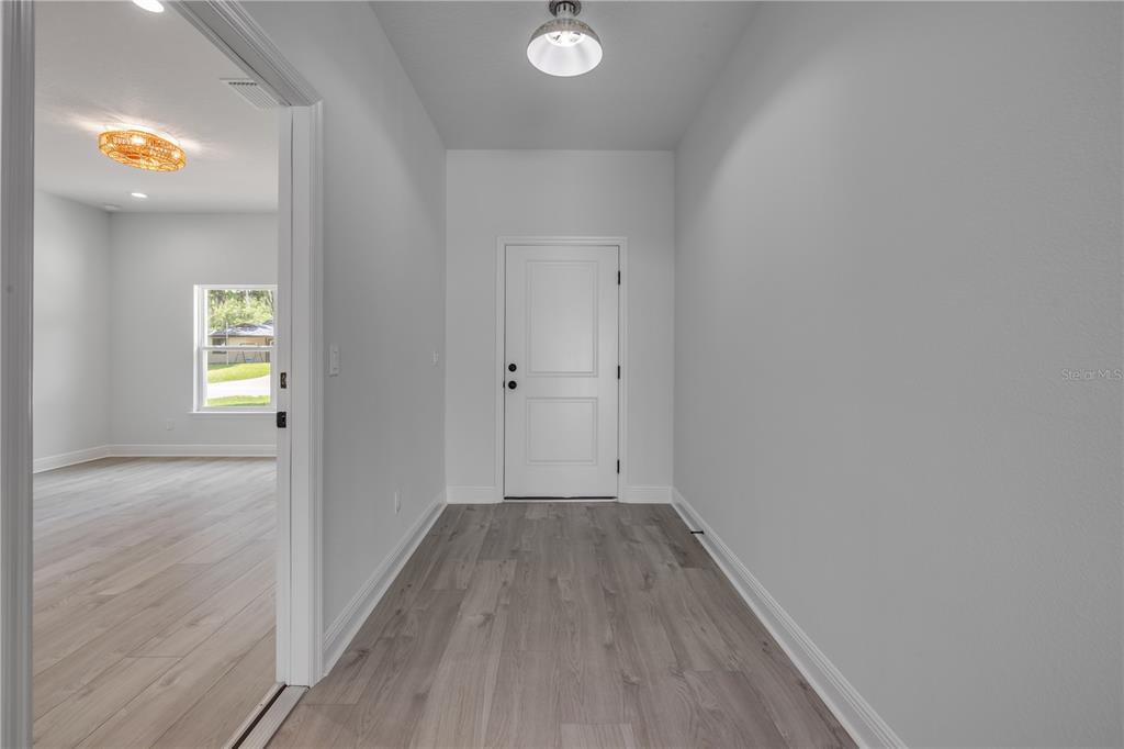 2324 Orange Tree Drive Edgewater, FL 32141 - Photo 9 of 59 wooden floor in an empty room with a window