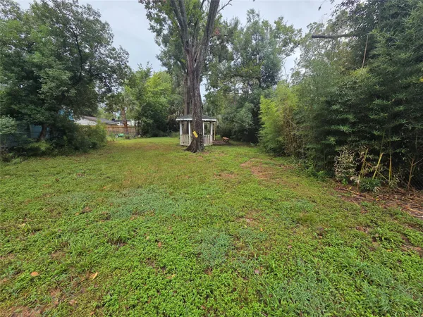 a view of a field with trees in the background