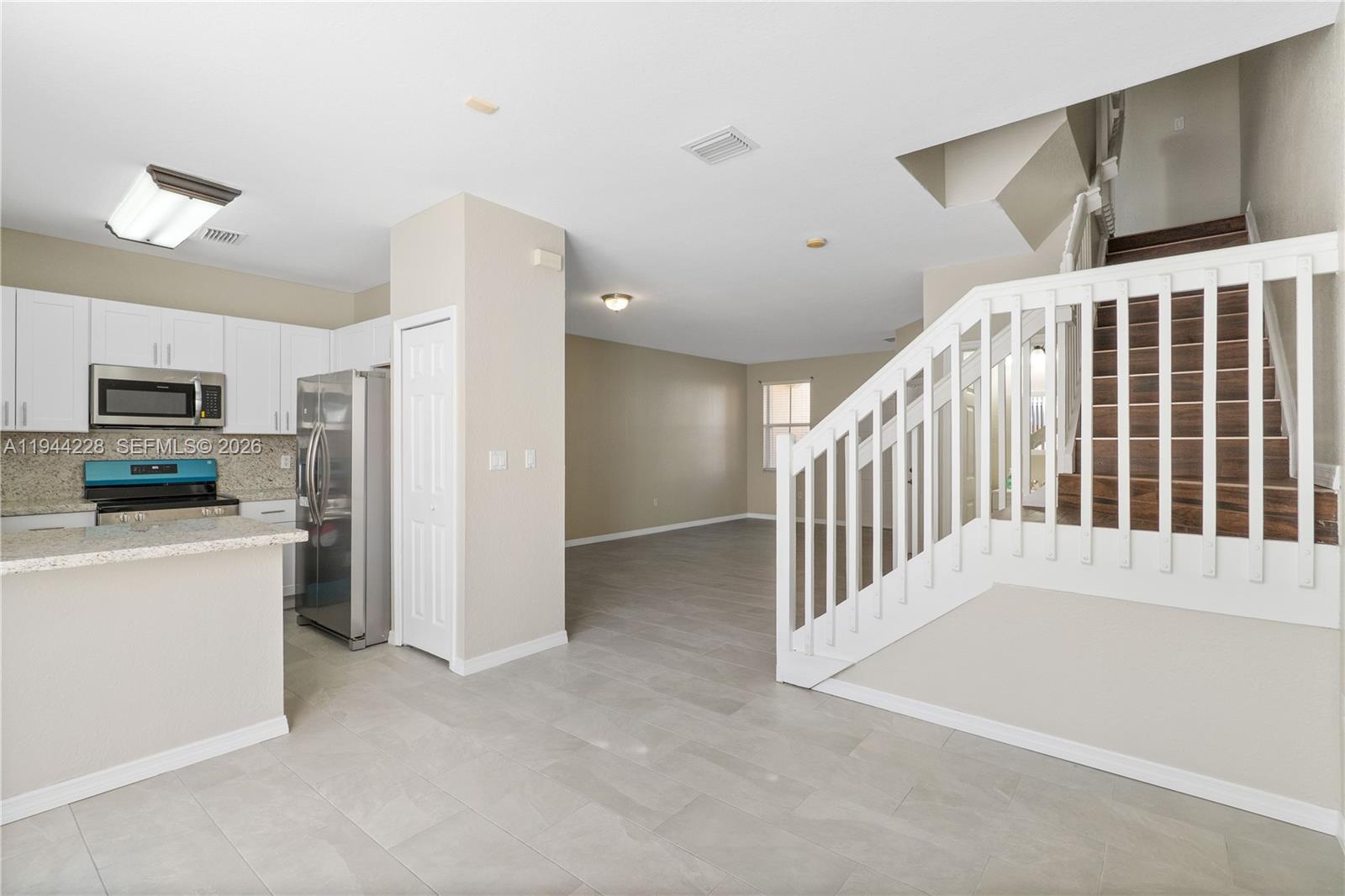12476 Southwest 122nd Street Miami, FL 33186 - Photo 2 of 18 a view of a kitchen with a refrigerator a stove top oven cabinets
