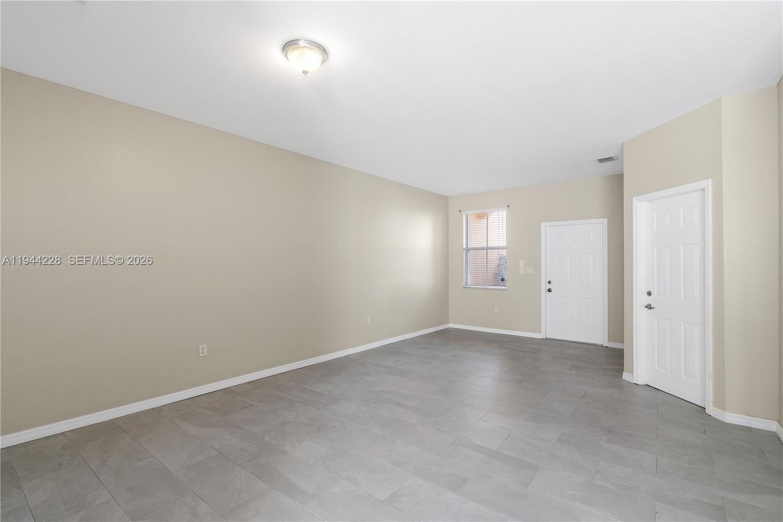 12476 Southwest 122nd Street Miami, FL 33186 - Photo 4 of 18 a view of an empty room and window