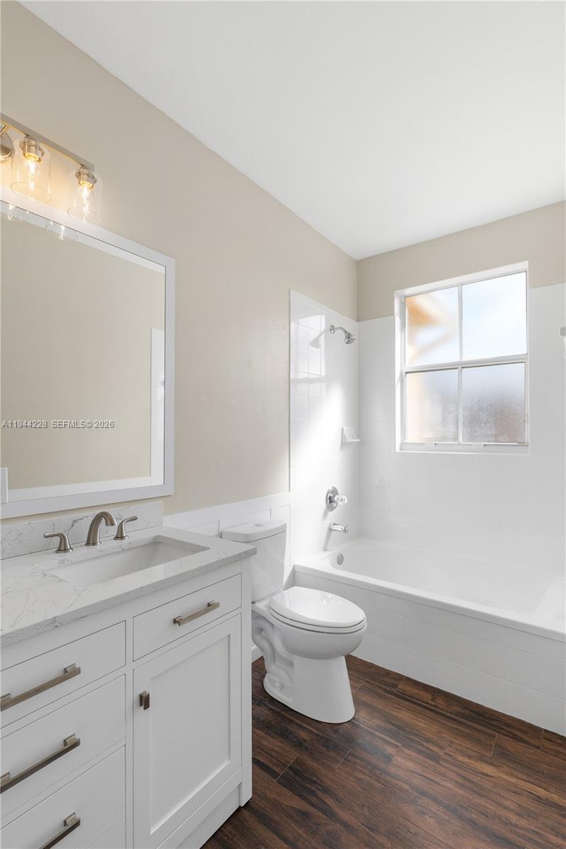 12476 Southwest 122nd Street Miami, FL 33186 - Photo 10 of 18 a bathroom with a sink toilet a mirror and window