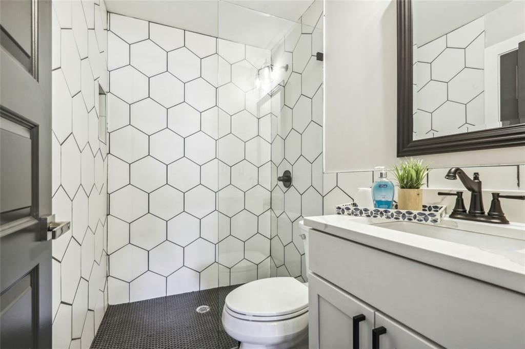 2145 Park Terrace Atlanta, GA 30337 - Photo 16 of 24 a bathroom with a sink a toilet and a mirror