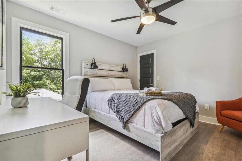 2145 Park Terrace Atlanta, GA 30337 - Photo 18 of 24 a bedroom with a large bed and a potted plant