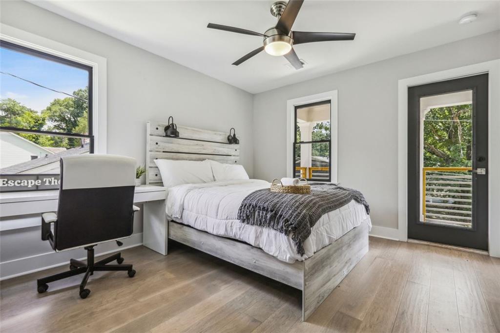 2145 Park Terrace Atlanta, GA 30337 - Photo 19 of 24 a spacious bedroom with a bed a computer on desk and a dresser
