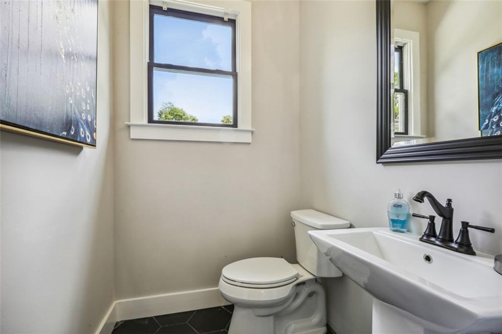 2145 Park Terrace Atlanta, GA 30337 - Photo 23 of 24 a bathroom with a toilet sink and mirror