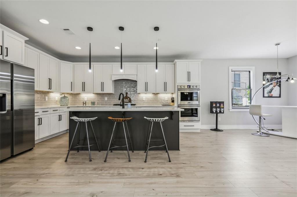 2145 Park Terrace Atlanta, GA 30337 - Photo 7 of 24 a kitchen with stainless steel appliances kitchen island granite countertop a sink and cabinets