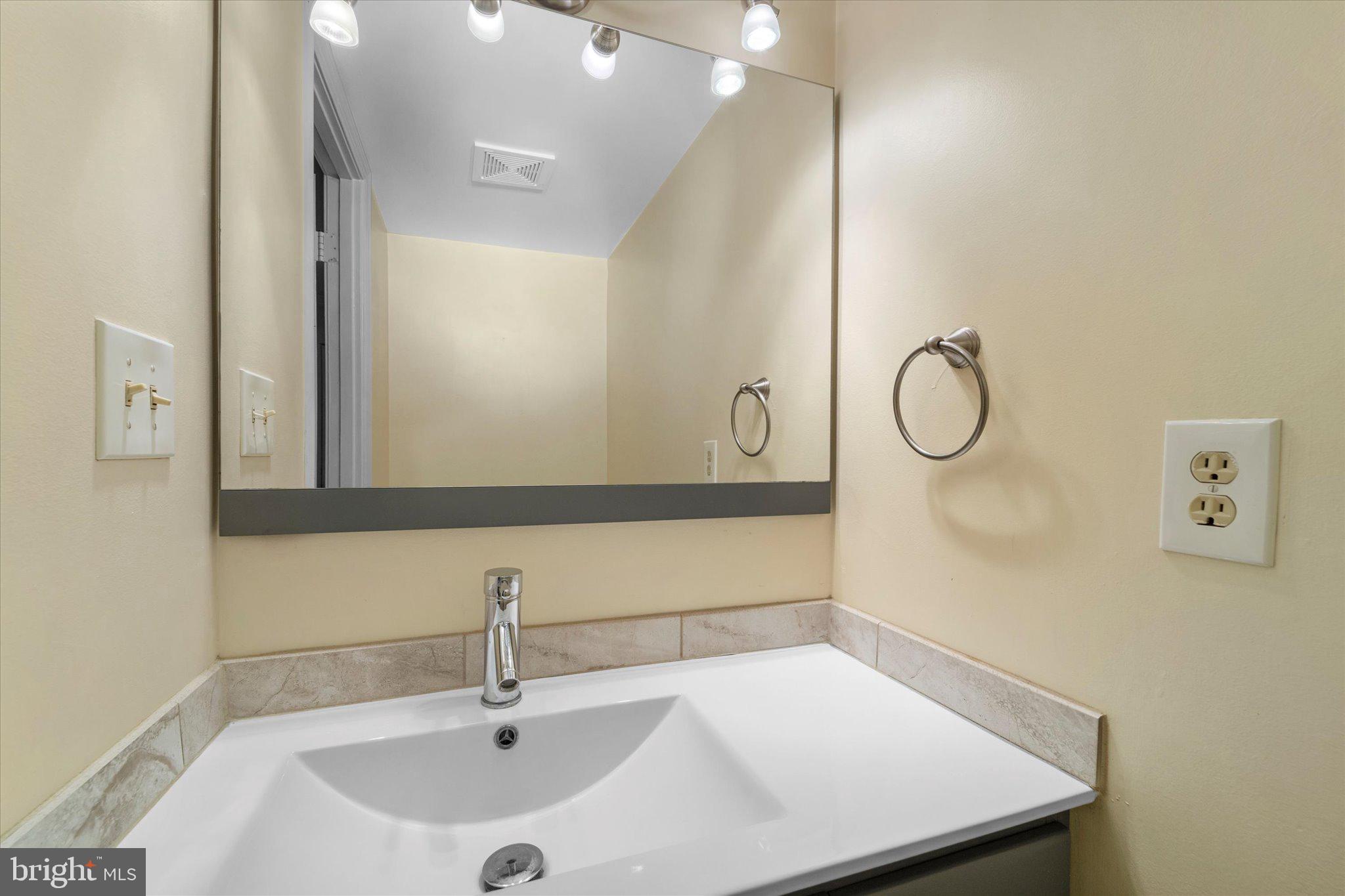 7907 Forest Path Way Springfield, VA 22153 - Photo 12 of 34 a bathroom with a sink and a mirror