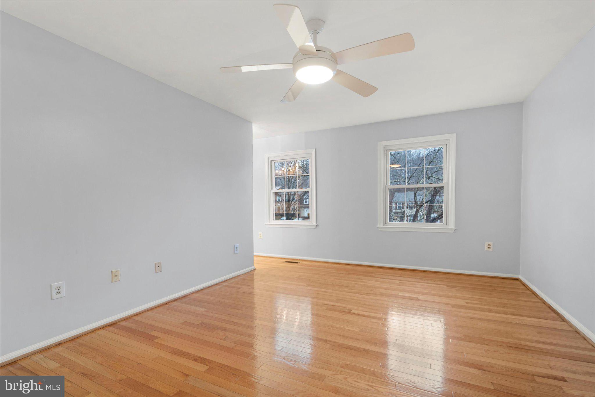 7907 Forest Path Way Springfield, VA 22153 - Photo 15 of 34 an empty room with wooden floor and windows