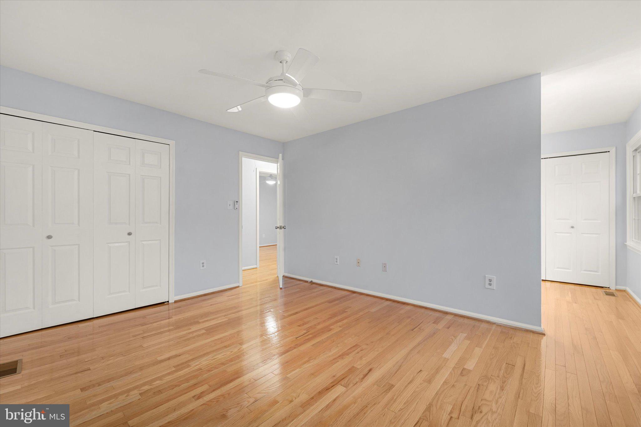 7907 Forest Path Way Springfield, VA 22153 - Photo 16 of 34 a view of an empty room with wooden floor