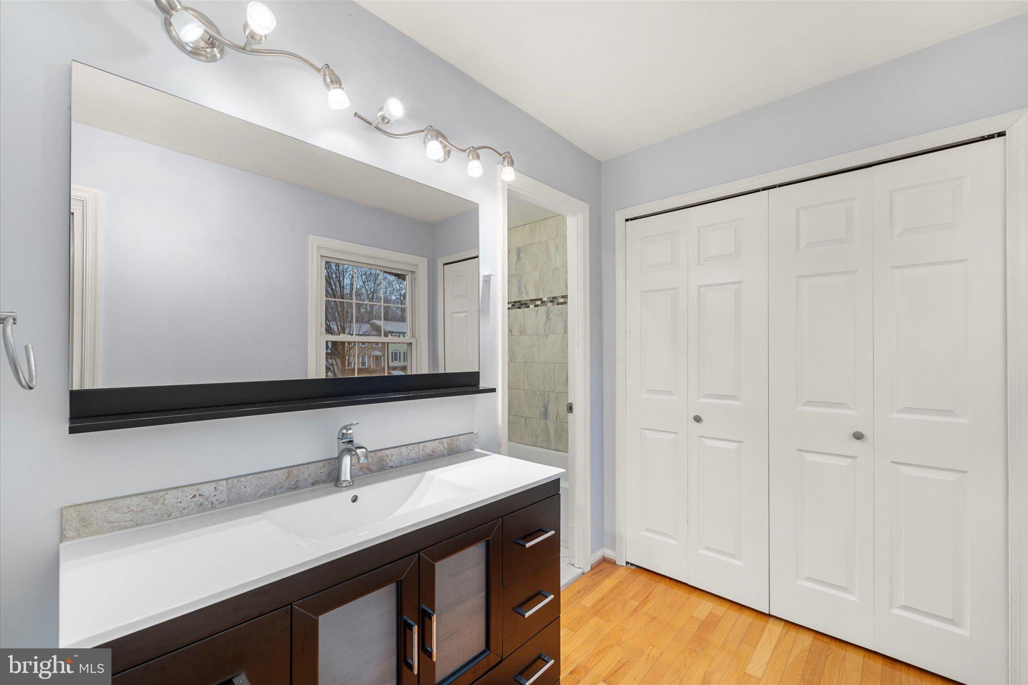 7907 Forest Path Way Springfield, VA 22153 - Photo 17 of 34 a bathroom with a sink vanity and a mirror