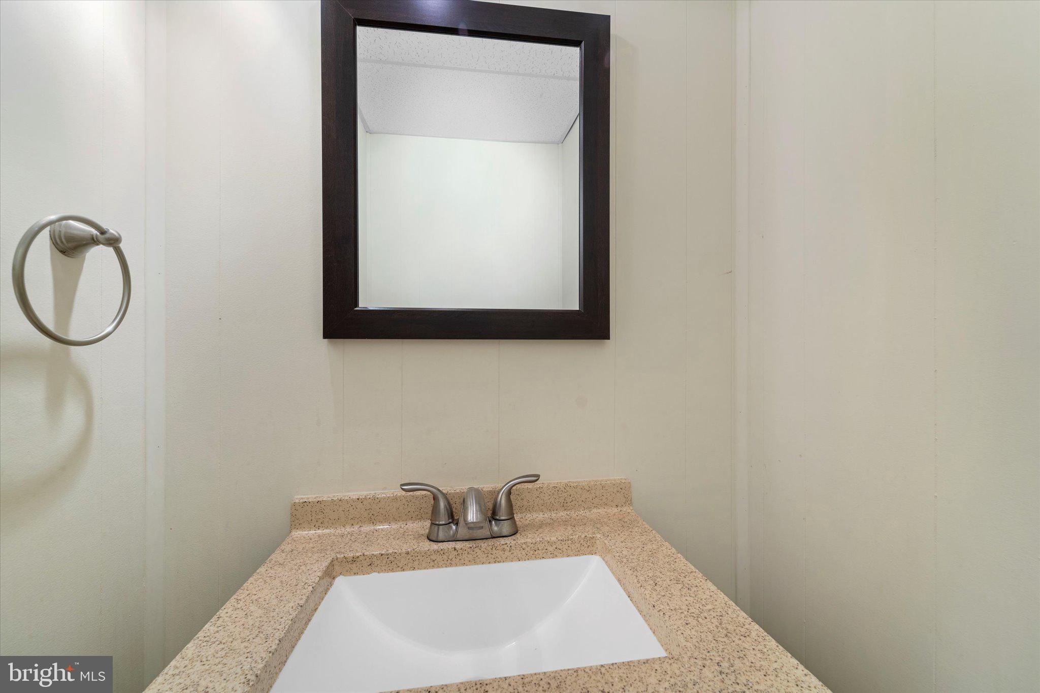 7907 Forest Path Way Springfield, VA 22153 - Photo 28 of 34 a bathroom with a sink and a mirror