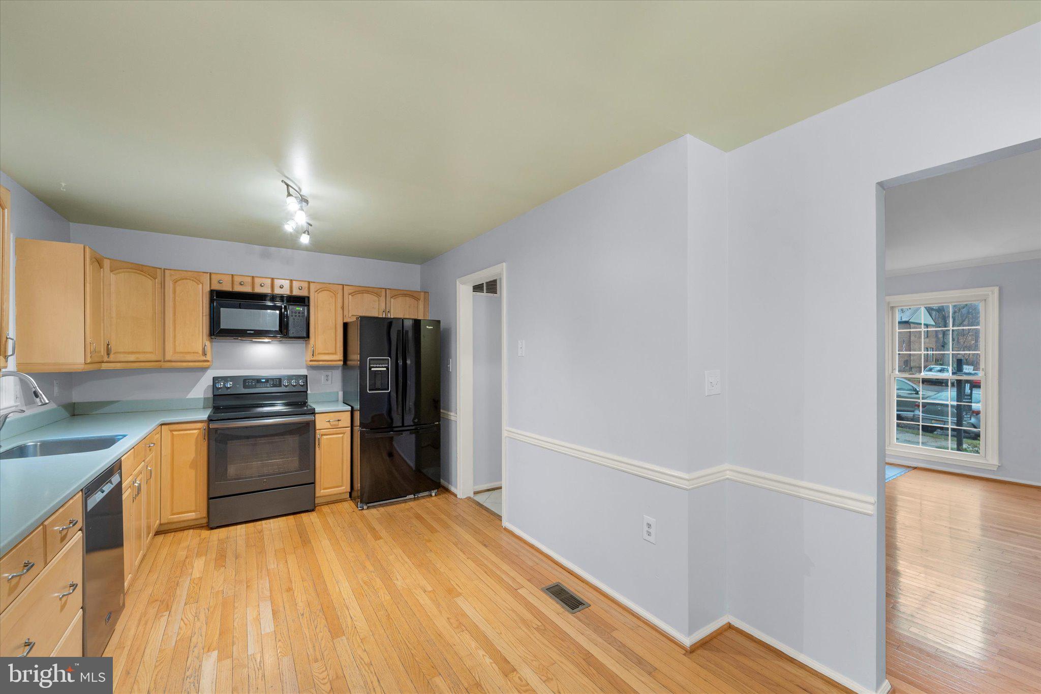 7907 Forest Path Way Springfield, VA 22153 - Photo 6 of 34 a kitchen with stainless steel appliances a refrigerator and a stove top oven