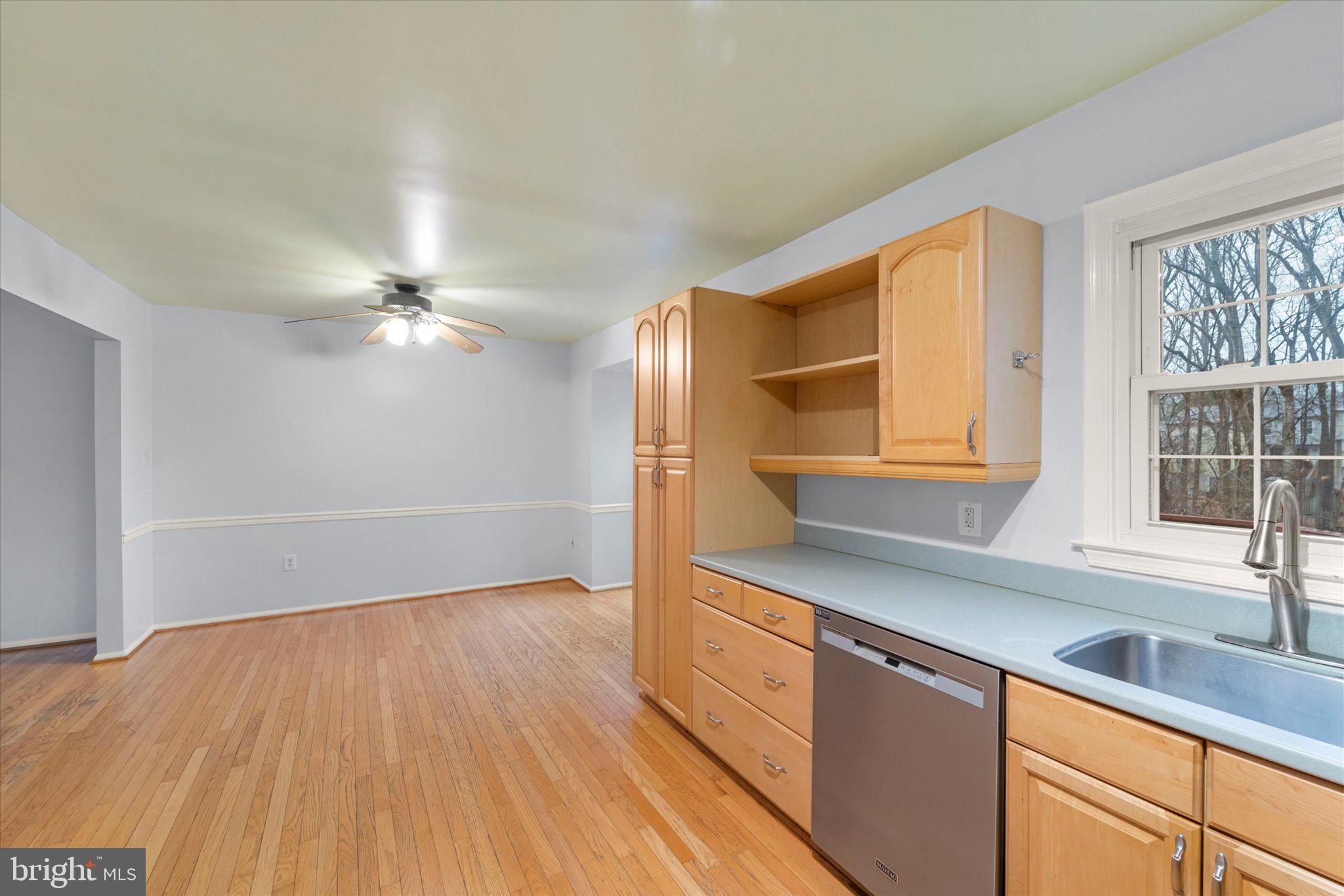 7907 Forest Path Way Springfield, VA 22153 - Photo 8 of 34 a kitchen with granite countertop a sink cabinets and wooden floor