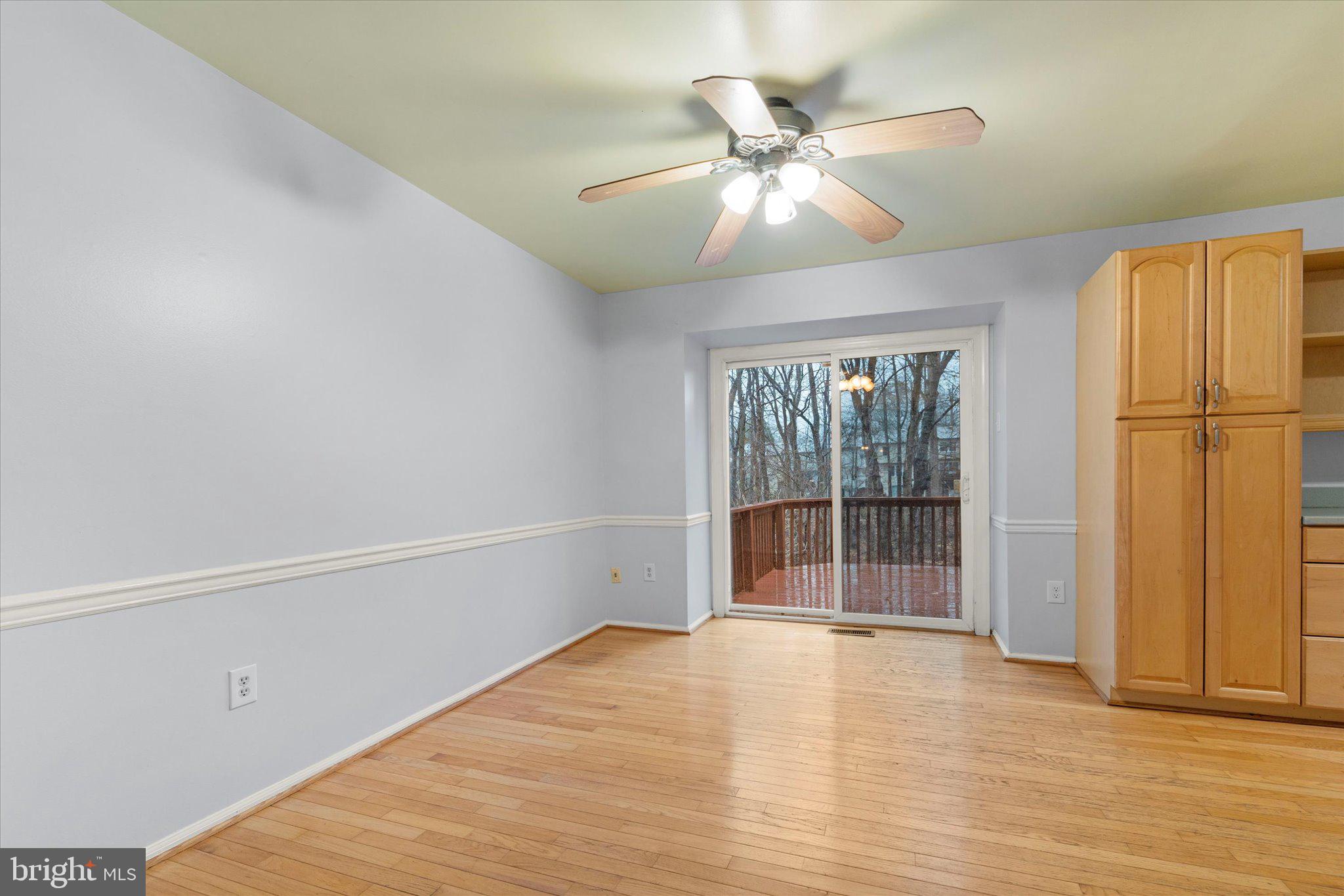 7907 Forest Path Way Springfield, VA 22153 - Photo 9 of 34 an empty room with wooden floor closet and windows