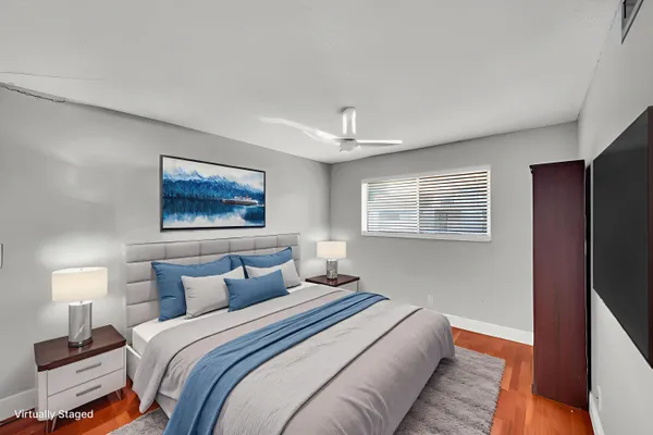 a bedroom with bed and a night stand