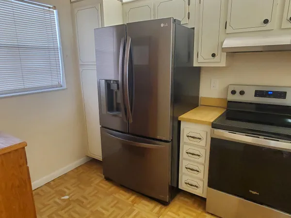a kitchen with appliances and a refrigerator
